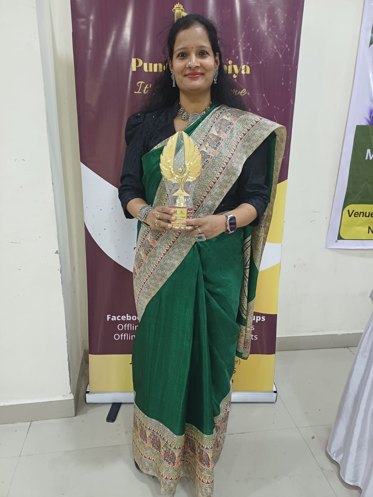 Jyoti Maheswari receiving an award trophy at a professional felicitation event
